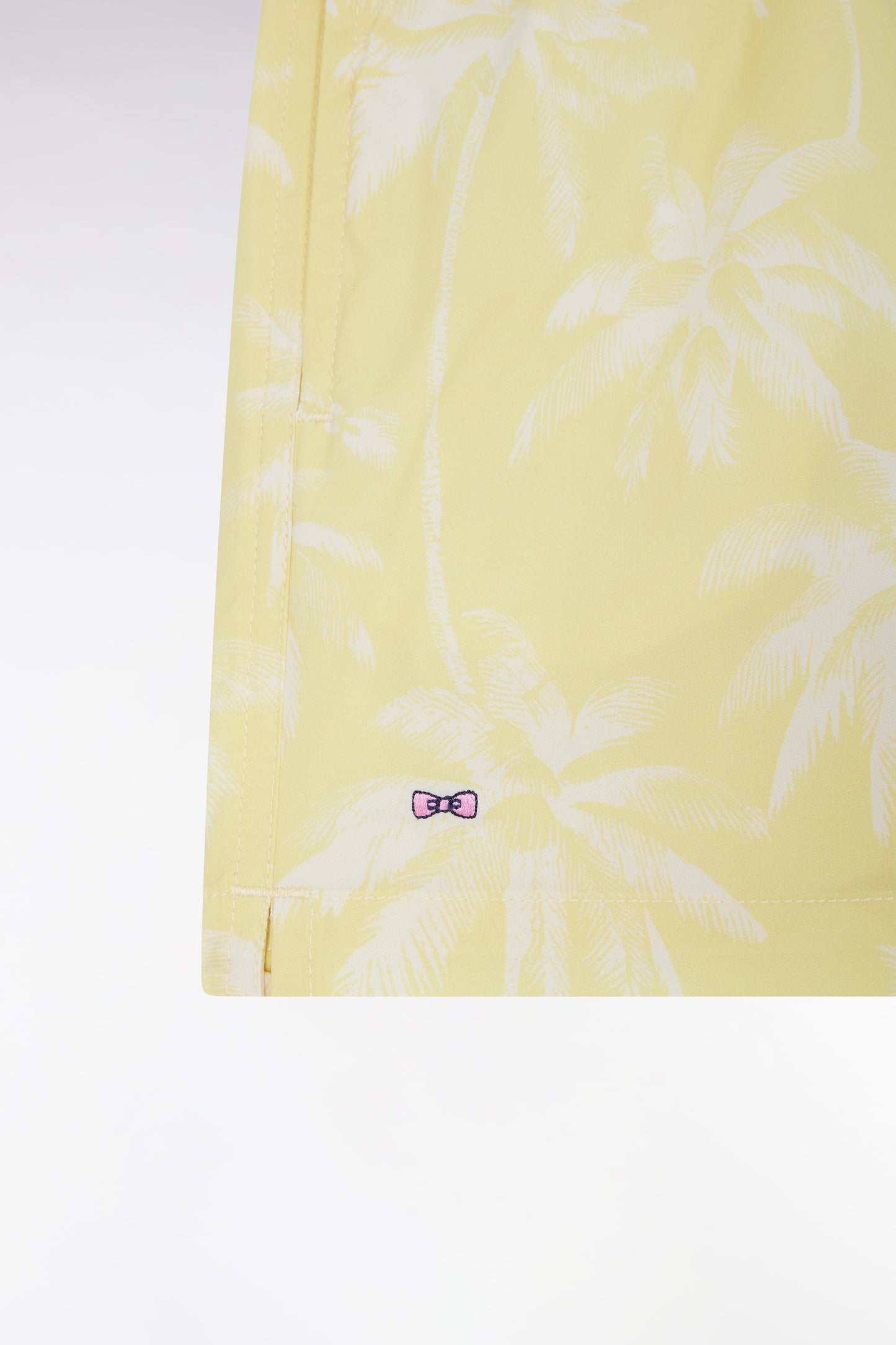 Yellow children's swimsuit with palm tree print