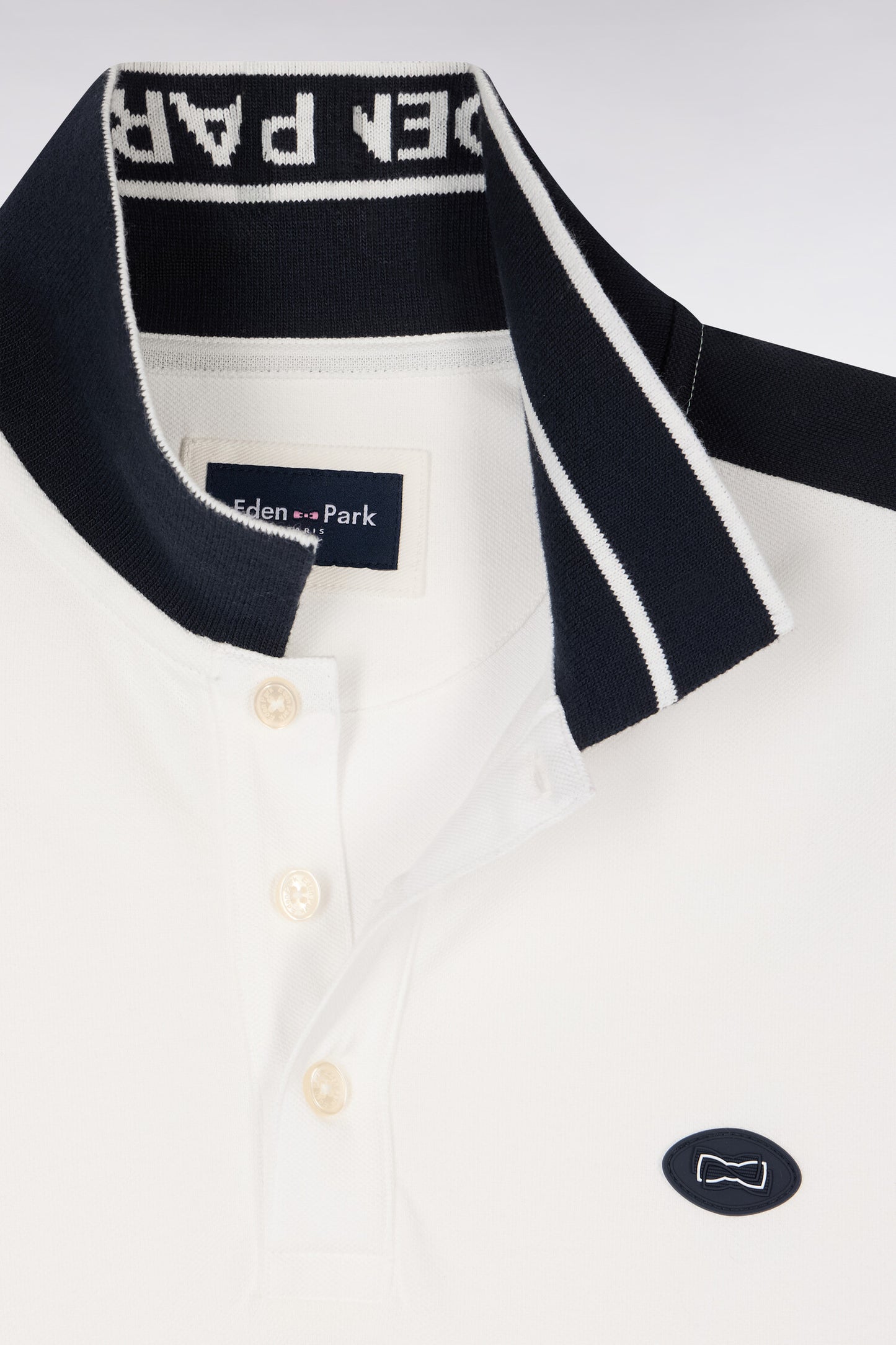Short-sleeved polo shirt in ecru cotton pique with navy cutouts
