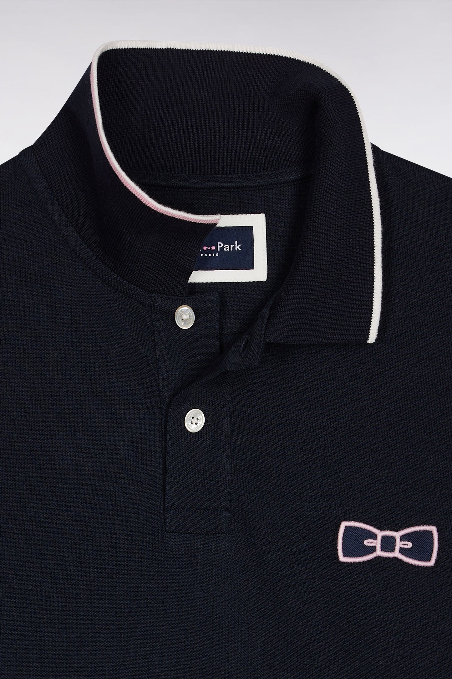 Two-tone navy and pink long-sleeved polo with bow tie