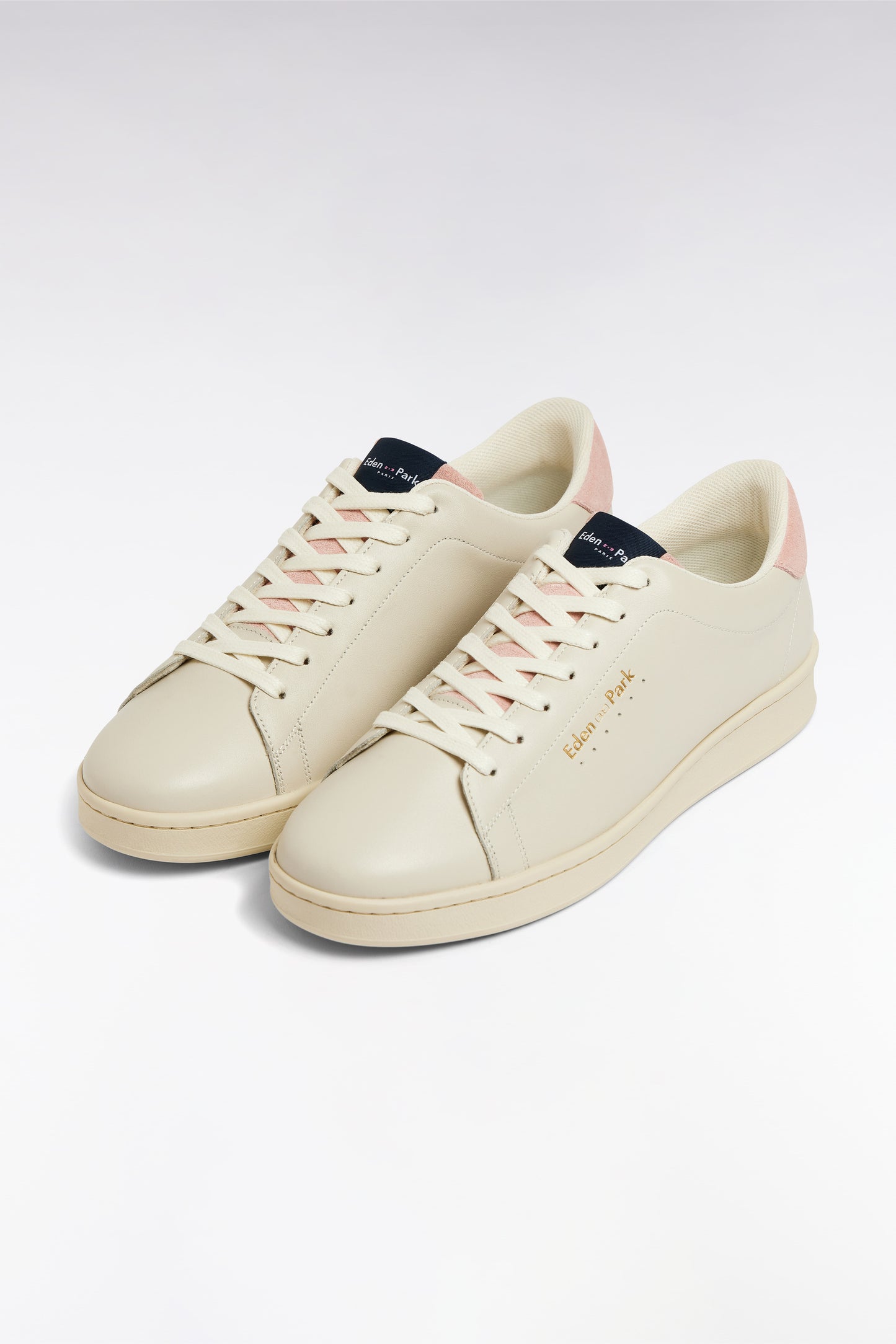 White leather low-top sneakers with pink accents