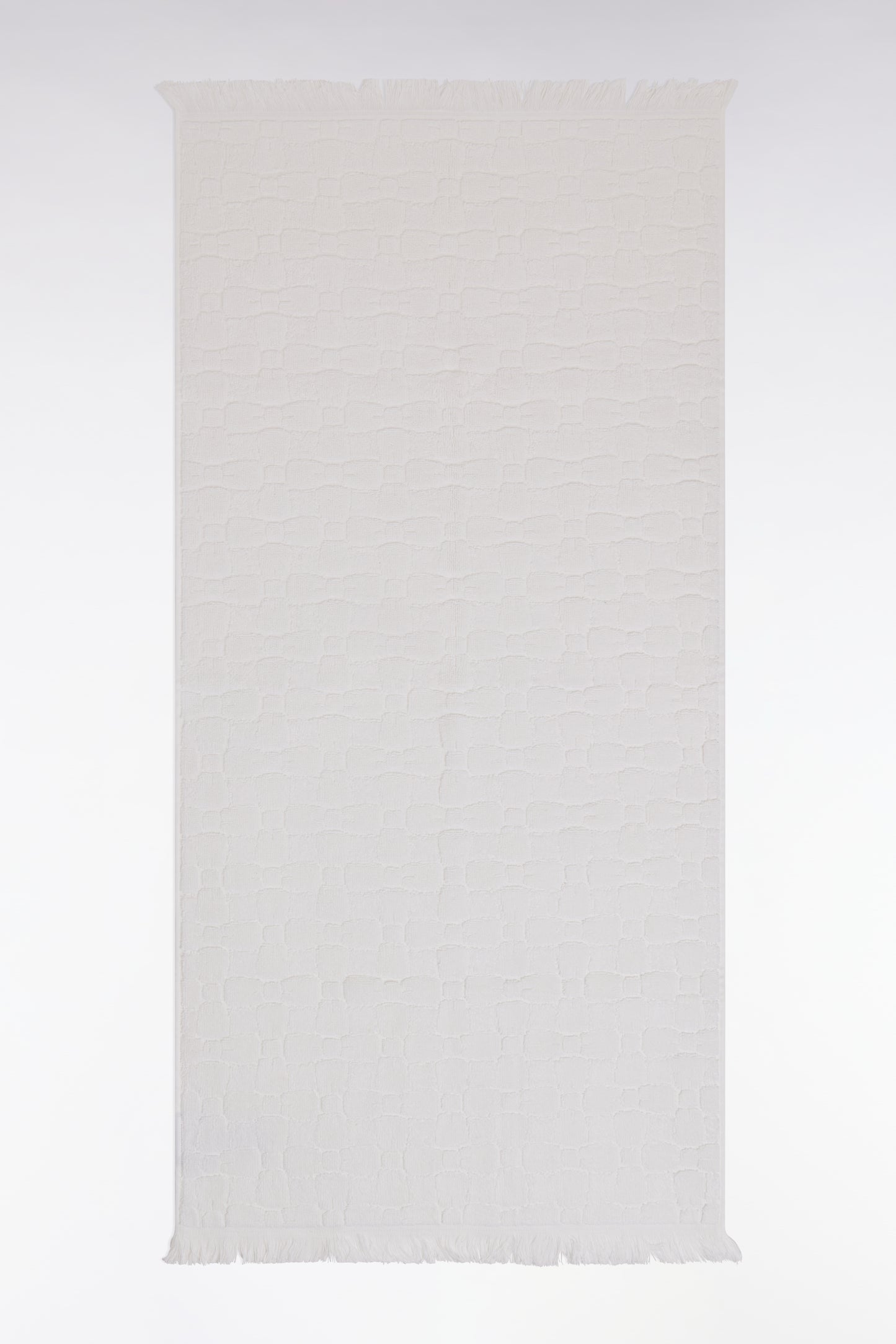 White cotton hand towel with micro bow tie patterns