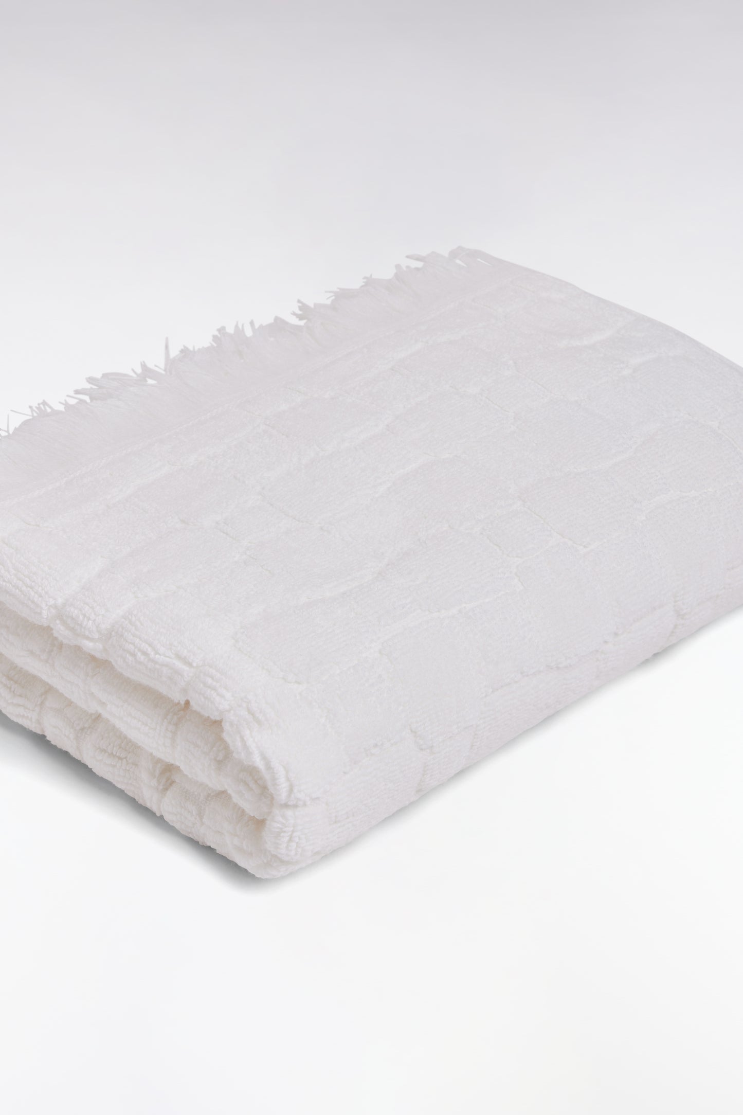 White cotton hand towel with micro bow tie patterns