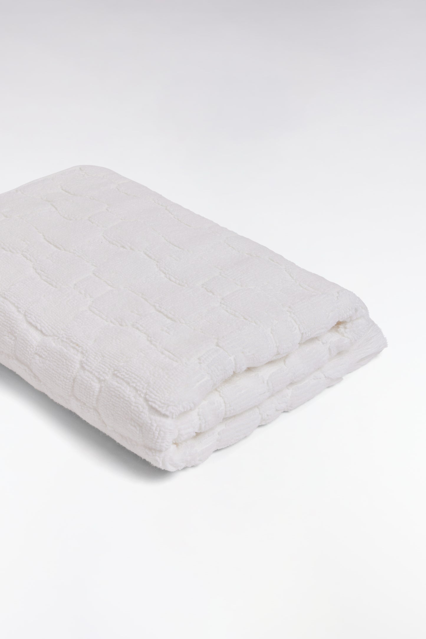 White cotton hand towel with micro bow tie patterns