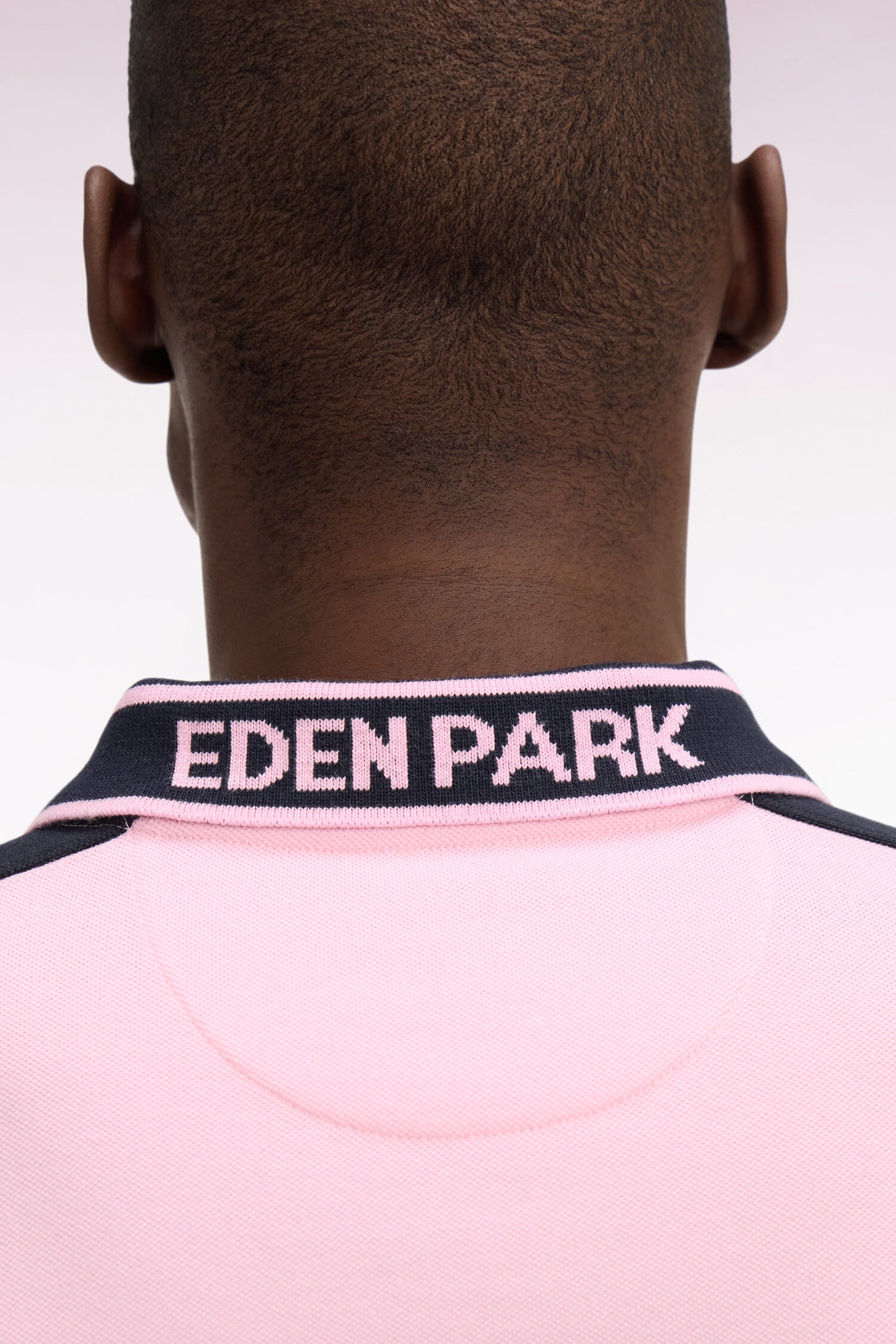 Short-sleeved polo shirt in pink cotton pique with navy cutouts