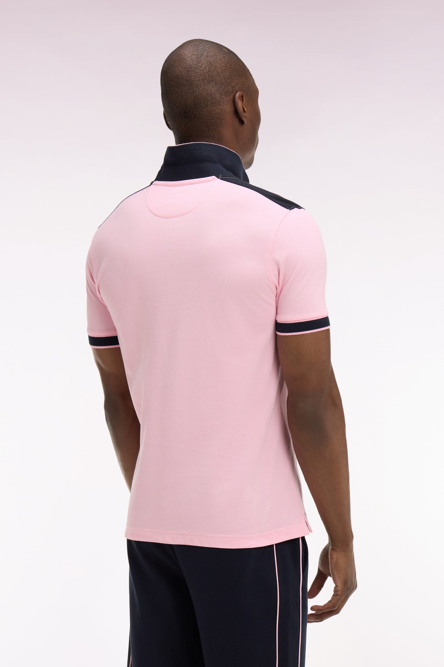 Short-sleeved polo shirt in pink cotton pique with navy cutouts