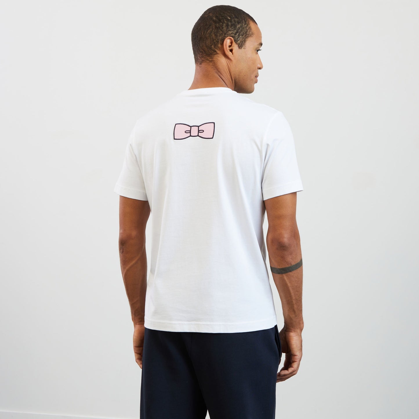 White T-shirt with embroidered bow tie on the back