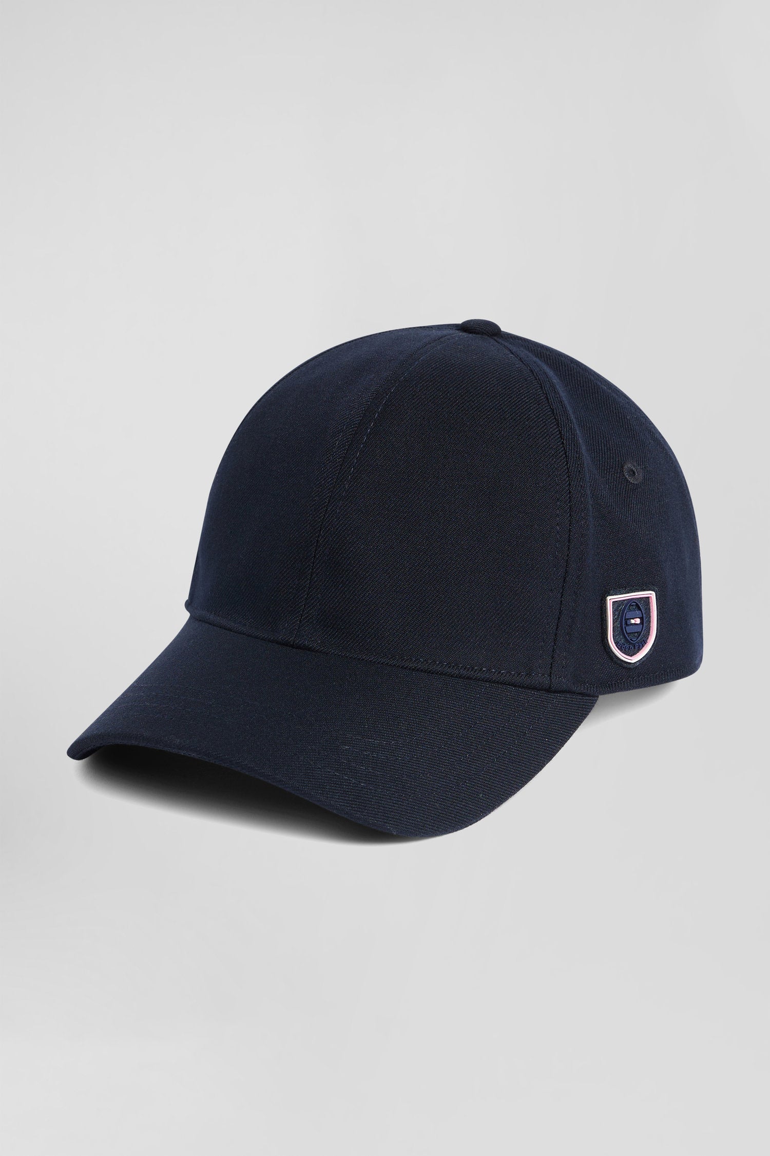 Navy blue cap with rubber badge and tricolour trim