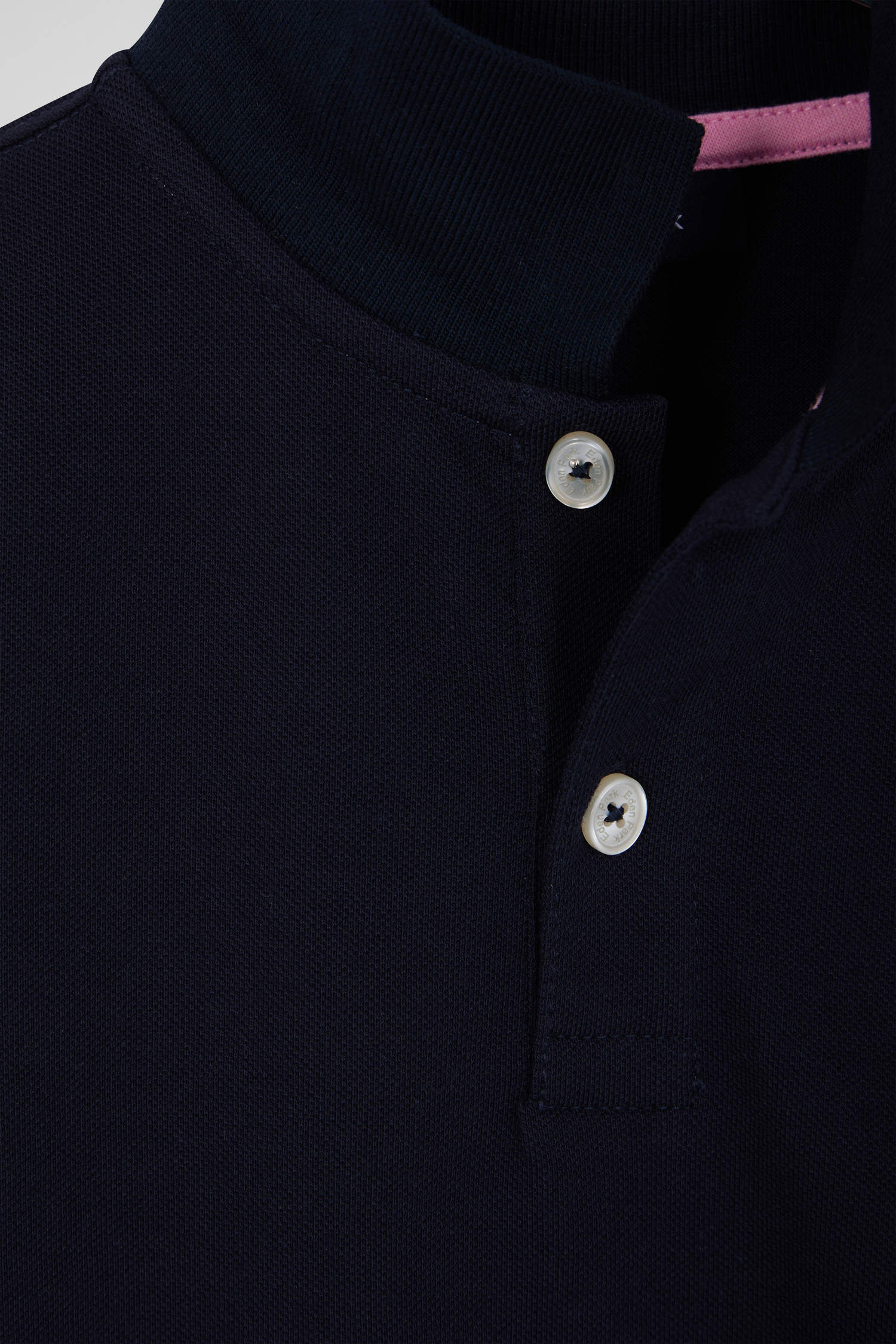 Regular navy blue short-sleeved cotton piqué polo shirt with back bow tie embroidery