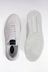 White leather sneakers with navy logo tongue